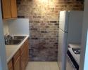 Each apartment is equipped with a full sized kitchen that comes with a refrigerator and stove. 