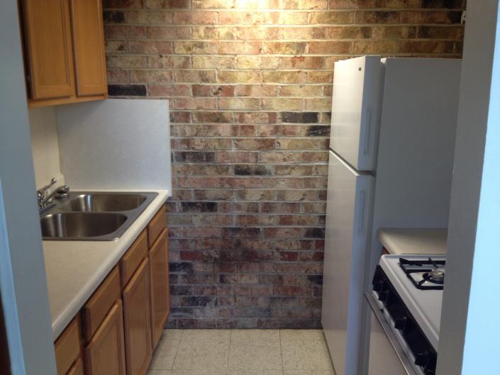 Each apartment is equipped with a full sized kitchen that comes with a refrigerator and stove. 
